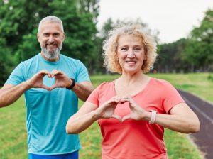 man holding up heart symbol